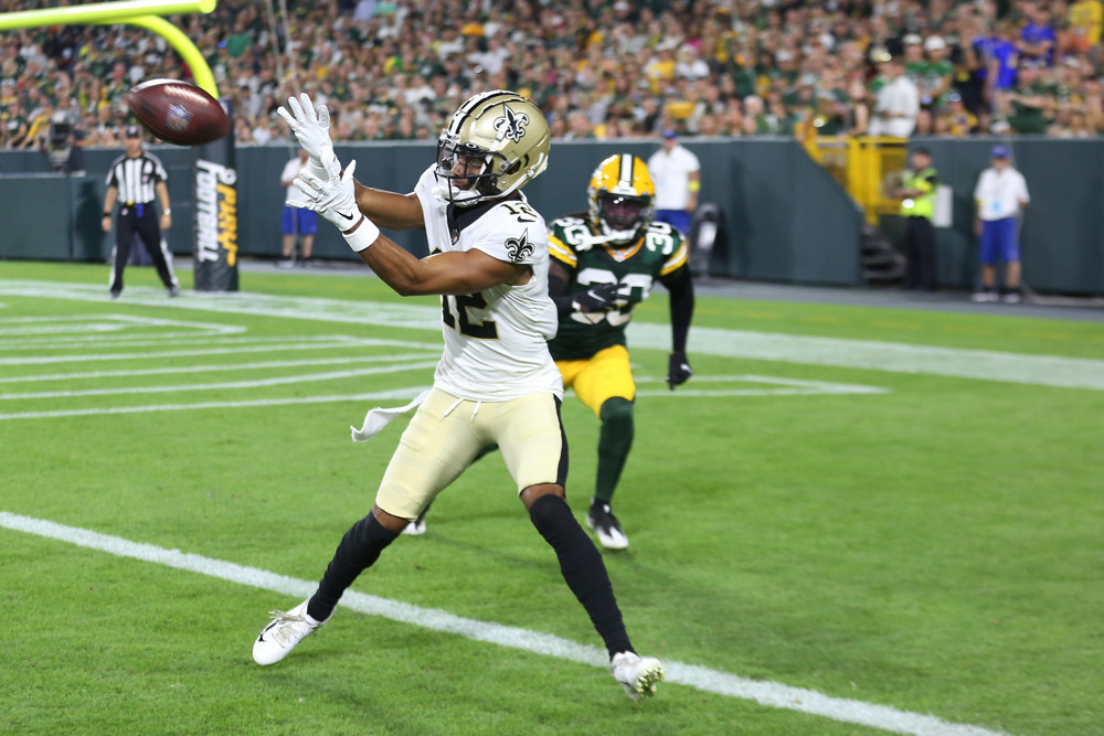 GREEN BAY, WI - AUGUST 19: New Orleans Saints wide receiver Chris Olave (12) catches a touchdown pass during an NFL preseason game between the Green Bay Packers and the New Orleans Saints on August 19, 2022, at Lambeau Field in Green Bay, WI. (Photo by Larry Radloff/Icon Sportswire)